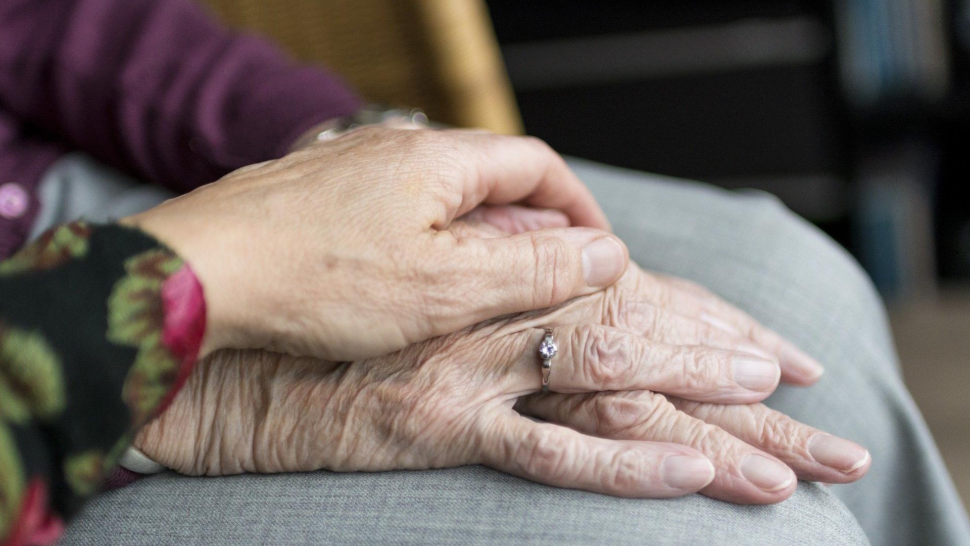 Stimmungsbild zum Beitrag: Es werden aufeinander gelegte Hände von älteren Personen abgebildet.